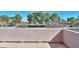 A balcony view shows a street with a church or community building and mature trees on a sunny day at 1980 N Santa Fe Ct, Casa Grande, AZ 85122