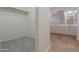 A linen closet offers storage next to a view of the bathroom with a double vanity and neutral color scheme at 1980 N Santa Fe Ct, Casa Grande, AZ 85122