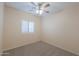 Cozy bedroom with neutral carpet, ceiling fan, and natural light from the window at 1980 N Santa Fe Ct, Casa Grande, AZ 85122