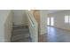 Inviting entryway with carpeted stairs and wood-look tile flooring leading to a bright, open space at 1980 N Santa Fe Ct, Casa Grande, AZ 85122