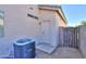 Exterior shot showing a back door, AC unit, and access to the backyard through a black metal gate at 1980 N Santa Fe Ct, Casa Grande, AZ 85122