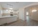 Bright kitchen featuring white cabinetry, stainless steel appliances, and an island with breakfast bar at 1980 N Santa Fe Ct, Casa Grande, AZ 85122