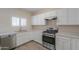 Efficient kitchen layout with stainless steel appliances and bright white cabinetry at 1980 N Santa Fe Ct, Casa Grande, AZ 85122