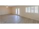 Bright living room with tile flooring, ceiling fan, white plantation shutters, and glass patio door at 1980 N Santa Fe Ct, Casa Grande, AZ 85122