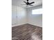 Bedroom with hardwood floors, a ceiling fan, a new door, and a window at 2031 E Don Carlos Ave, Tempe, AZ 85281