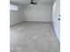 Bright living room featuring tile floors, a ceiling fan, mini split unit, and windows at 2031 E Don Carlos Ave, Tempe, AZ 85281