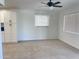 Bright living room featuring tile floors, a ceiling fan, large windows, and large storage cabinet at 2031 E Don Carlos Ave, Tempe, AZ 85281