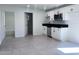 Updated living area with tile floors, white walls, and a view to a partial kitchen area at 2031 E Don Carlos Ave, Tempe, AZ 85281