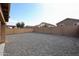 Spacious backyard with rock ground cover and a block wall fence at 22473 W Woodlands Ave, Buckeye, AZ 85326