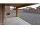 View of the backyard featuring rock ground cover and a covered patio at 22473 W Woodlands Ave, Buckeye, AZ 85326