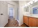 Bathroom featuring a wood cabinet vanity, tile floors, and a glass shower door at 22473 W Woodlands Ave, Buckeye, AZ 85326