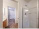 Bright bathroom featuring a glass enclosed shower and a hallway leading to another room at 22473 W Woodlands Ave, Buckeye, AZ 85326