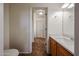 Bathroom featuring a single sink vanity and a view into the adjacent rooms at 22473 W Woodlands Ave, Buckeye, AZ 85326