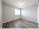 Bedroom featuring wood-look flooring, neutral paint, window and base trim at 22473 W Woodlands Ave, Buckeye, AZ 85326