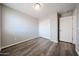 Bedroom features wood-look flooring, neutral paint and standard closet at 22473 W Woodlands Ave, Buckeye, AZ 85326