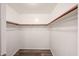 Walk-in closet with wood floors and white walls at 22473 W Woodlands Ave, Buckeye, AZ 85326