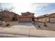 Charming two-story home with a well-maintained lawn and a spacious driveway at 22473 W Woodlands Ave, Buckeye, AZ 85326