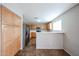 An open kitchen with stainless steel appliances, light wood cabinets, and a breakfast bar at 22473 W Woodlands Ave, Buckeye, AZ 85326