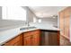 A modern kitchen with a stainless steel sink, light wood cabinets, and white quartz countertops at 22473 W Woodlands Ave, Buckeye, AZ 85326