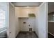 Spacious laundry room featuring an open design with white shelving and utility hookups at 22473 W Woodlands Ave, Buckeye, AZ 85326