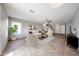 Bright living room featuring neutral tones, tile flooring, and ample natural light at 22473 W Woodlands Ave, Buckeye, AZ 85326