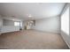 Spacious living room with plush carpeting, neutral paint and recessed lighting, perfect for relaxing and entertaining at 22473 W Woodlands Ave, Buckeye, AZ 85326