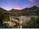 Stunning twilight aerial view of the property featuring a pool, fire pit, and mountain views at 24019 N 112Th Pl, Scottsdale, AZ 85255