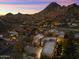 Night aerial of the house showing surrounding desert community and mountain views at 24019 N 112Th Pl, Scottsdale, AZ 85255