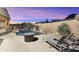 Beautiful backyard pool with fire pit, lounge chairs, desert landscaping and mountain views at 24019 N 112Th Pl, Scottsdale, AZ 85255