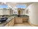 Luxurious bathroom with dual vessel sinks, granite countertops, and ample cabinet space at 24019 N 112Th Pl, Scottsdale, AZ 85255