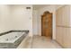 Bathroom boasting a soaking tub with a granite surround and custom cabinetry at 24019 N 112Th Pl, Scottsdale, AZ 85255