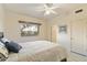 Bright bedroom featuring a ceiling fan, window and comfortable bed with decorative pillows at 24019 N 112Th Pl, Scottsdale, AZ 85255