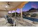 Enjoy a covered patio with ceiling fans overlooking a sparkling pool, lush landscaping, and beautiful desert mountain views at 24019 N 112Th Pl, Scottsdale, AZ 85255