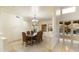 Bright dining room with a live edge table, designer chandelier, and neutral color palette at 24019 N 112Th Pl, Scottsdale, AZ 85255