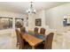 Dining area with a live edge table, six chairs, and views of the natural desert landscape at 24019 N 112Th Pl, Scottsdale, AZ 85255