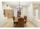 Spacious dining room featuring a live edge table, staircase access, and light-toned tile flooring at 24019 N 112Th Pl, Scottsdale, AZ 85255