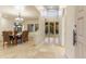 Home Foyer featuring tile flooring, chandelier, dining table, and doors to the outside at 24019 N 112Th Pl, Scottsdale, AZ 85255