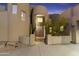 Close up of the front entrance of the home with stone walls, desert plants, and custom front door at 24019 N 112Th Pl, Scottsdale, AZ 85255