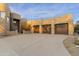 Wide driveway leading to the 3-car garage of a desert home at 24019 N 112Th Pl, Scottsdale, AZ 85255