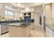 Kitchen featuring a large island, stainless steel appliances, and natural wood cabinetry at 24019 N 112Th Pl, Scottsdale, AZ 85255