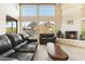 Well-lit living room showcasing tall windows offering panoramic views, a fireplace, and stylish furnishings at 24019 N 112Th Pl, Scottsdale, AZ 85255