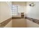 Tiled shower with glass block window and built-in niche at 24019 N 112Th Pl, Scottsdale, AZ 85255