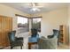 Cozy sitting room with comfortable chairs, a unique coffee table, and picturesque views from the windows at 24019 N 112Th Pl, Scottsdale, AZ 85255