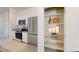 Modern kitchen features stainless steel appliances, white cabinets, and a pantry at 24183 W Hidalgo Ave, Buckeye, AZ 85326