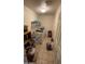 Functional laundry room with washer, dryer, shelving, and tiled floor at 25035 N 63Rd Dr, Phoenix, AZ 85083