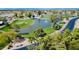 Stunning aerial view of the golf course featuring lush greens and serene water features at 25820 S Saddletree Dr, Sun Lakes, AZ 85248