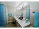 Bright bathroom with double sinks, a large mirror, and storage cabinets at 25820 S Saddletree Dr, Sun Lakes, AZ 85248