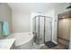 Corner bathtub with a glass enclosed shower in a naturally-lit bathroom at 25820 S Saddletree Dr, Sun Lakes, AZ 85248