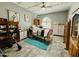 Cozy bedroom with a ceiling fan and tile floors; well-lit from the arched window at 25820 S Saddletree Dr, Sun Lakes, AZ 85248