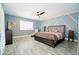 Spacious main bedroom with a ceiling fan, accent wall, and tile flooring at 25820 S Saddletree Dr, Sun Lakes, AZ 85248